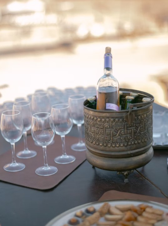 Rosé wine and glasses served at sunset aperitif in the Agafay desert
