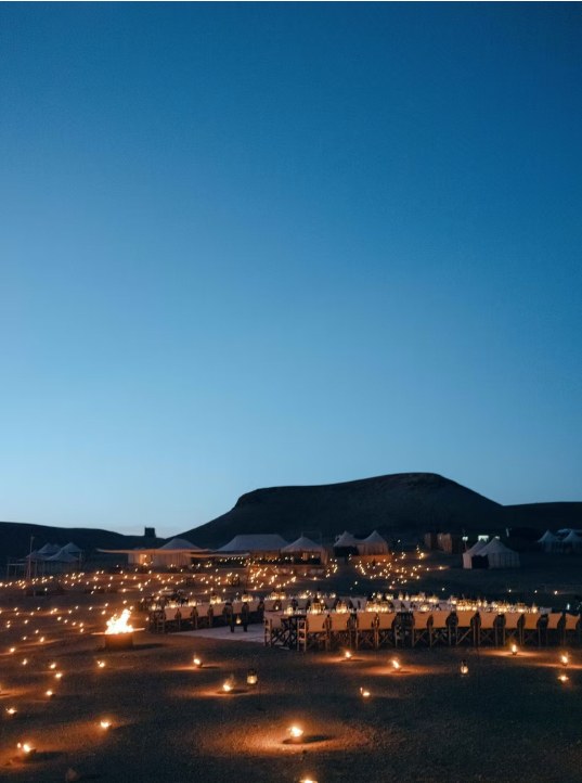 Hundreds of candles lighting a luxury camp at night in the Agafay desert
