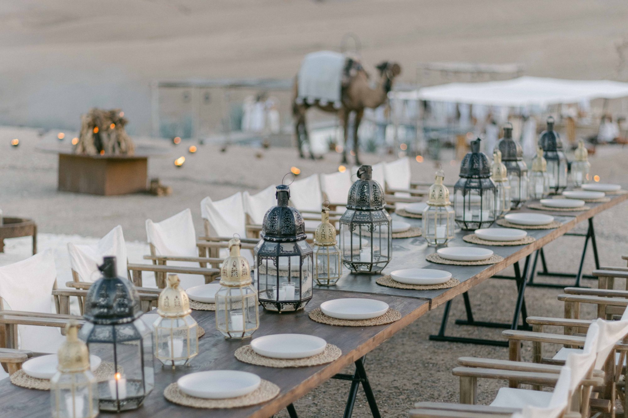 Wedding table with Moroccan lanterns and a camel in the Agafay desert