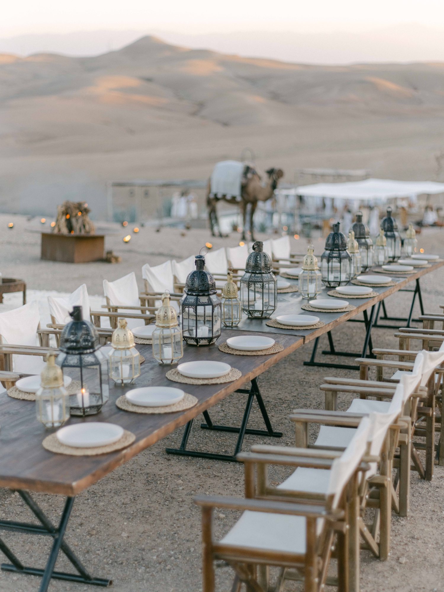 Lantern-lit dinner table and a camel for a vow renewal in the Agafay desert Lantern-lit dinner table and a camel for a vow renewal in the Agafay desert